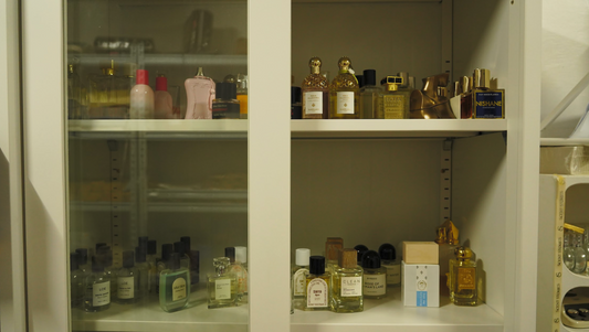 perfume collection in cabinet